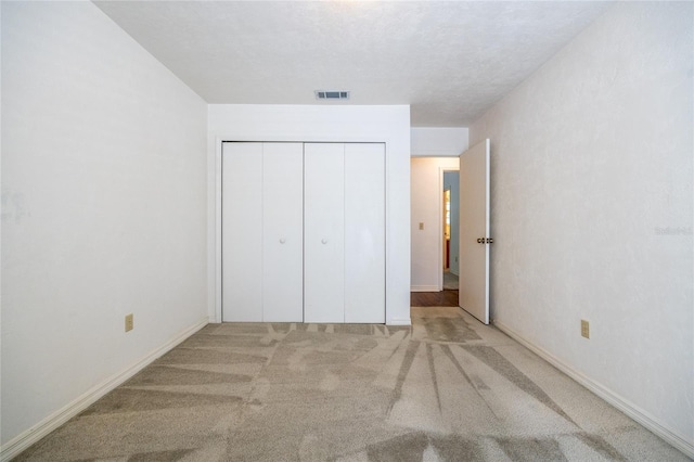 231 NW 48th Blvd Unit 0, Gainesville, FL 32607 - unfurnished bedroom featuring a closet, carpet floors, and baseboards