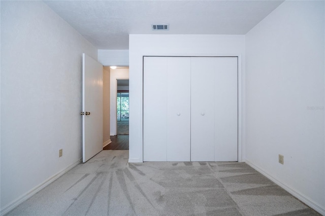 231 NW 48th Blvd Unit 0, Gainesville, FL 32607 - unfurnished bedroom with a closet, carpet, and baseboards