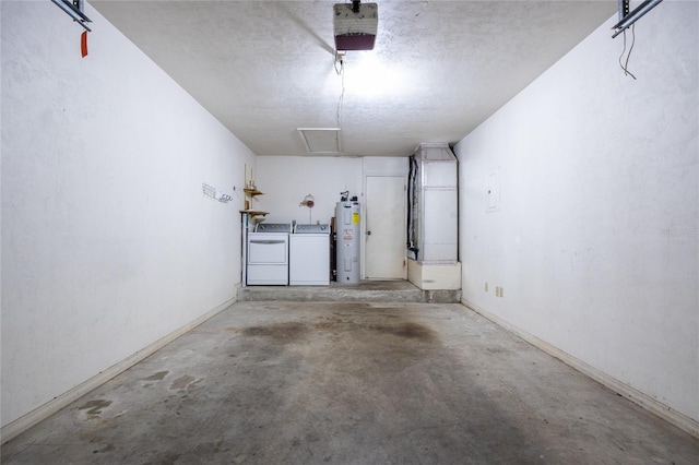 231 NW 48th Blvd Unit 0, Gainesville, FL 32607 - garage featuring washing machine and clothes dryer, water heater, a garage door opener, and baseboards