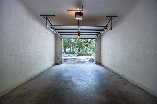 231 NW 48th Blvd Unit 0, Gainesville, FL 32607 - garage featuring a garage door opener and baseboards