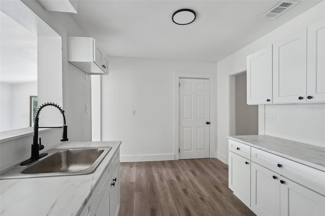20016 SE 219th Ave, Hawthorne, FL 32640 - kitchen featuring a sink, white cabinets, wood finished floors, baseboards, and light stone counters