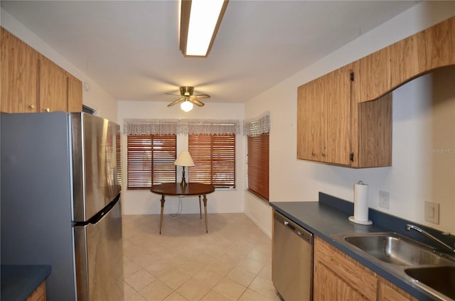 3425 NW 48th Ter, Gainesville, FL 32606 - kitchen featuring appliances with stainless steel finishes, a sink, dark countertops, ceiling fan, and baseboards