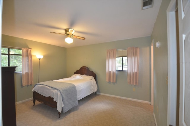 3425 NW 48th Ter, Gainesville, FL 32606 - carpeted bedroom featuring multiple windows, ceiling fan, and baseboards