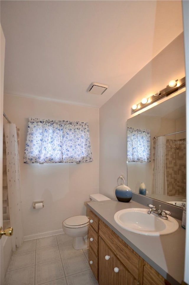 3425 NW 48th Ter, Gainesville, FL 32606 - full bathroom featuring toilet, vanity, curtained shower, and tile patterned floors