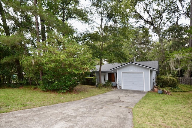 3425 NW 48th Ter, Gainesville, FL 32606 - view of front facade with a front lawn, driveway, an attached garage, and a shingled roof