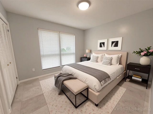 6015 SW 35th Way, Gainesville, FL 32608 - bedroom featuring a closet, baseboards, and light tile patterned floors