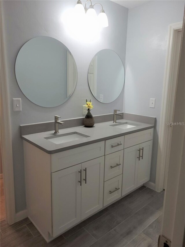 6015 SW 35th Way, Gainesville, FL 32608 - full bathroom featuring double vanity and wood finish floors