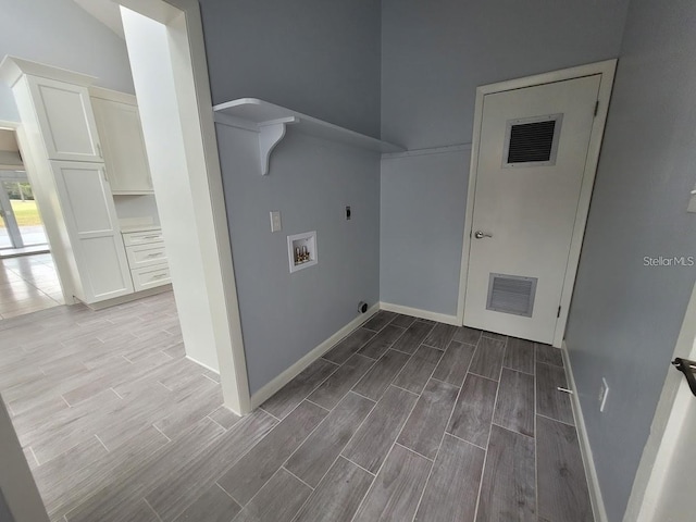 6015 SW 35th Way, Gainesville, FL 32608 - washroom featuring electric dryer hookup, hookup for a washing machine, wood finished floors, and baseboards