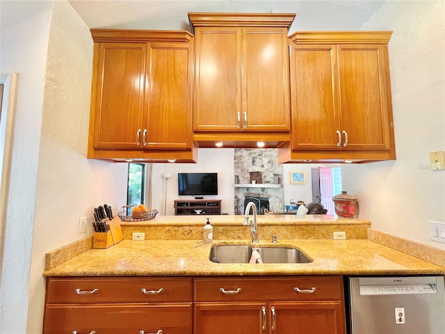 4370 NW 60th Ter, Gainesville, FL 32606 - kitchen featuring dishwasher, a sink, light stone countertops, brown cabinetry, and a peninsula