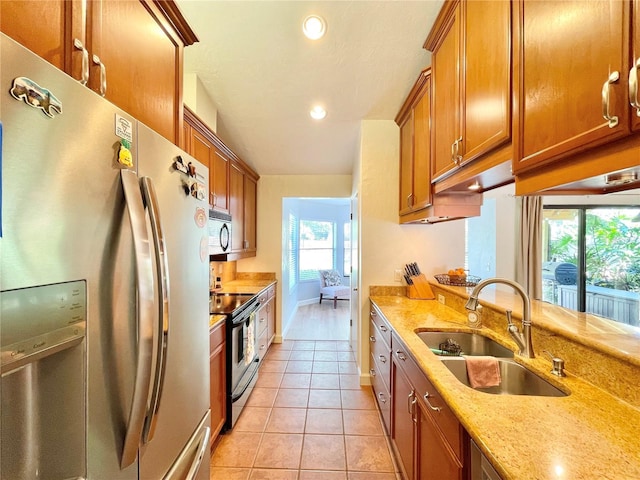 4370 NW 60th Ter, Gainesville, FL 32606 - kitchen with freestanding refrigerator, a sink, electric range, brown cabinets, and recessed lighting
