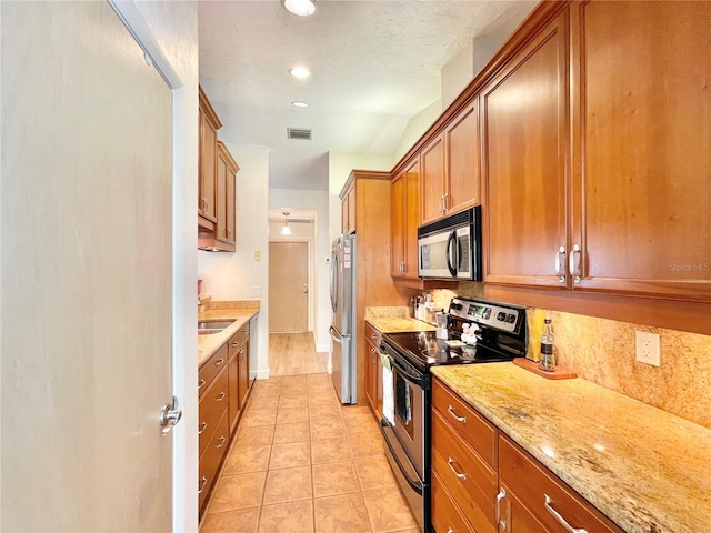 4370 NW 60th Ter, Gainesville, FL 32606 - kitchen featuring stainless steel appliances, brown cabinets, backsplash, light tile patterned floors, and recessed lighting