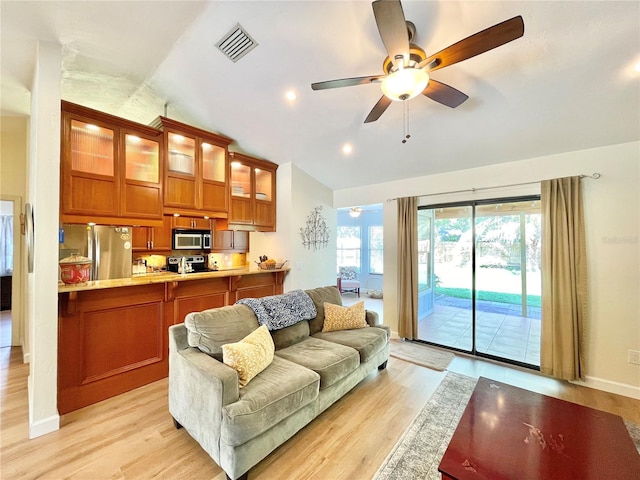 4370 NW 60th Ter, Gainesville, FL 32606 - living room featuring lofted ceiling, a ceiling fan, plenty of natural light, light wood-style flooring, and recessed lighting
