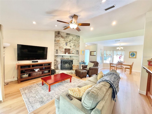 4370 NW 60th Ter, Gainesville, FL 32606 - living room featuring lofted ceiling, light wood-style flooring, ceiling fan, a fireplace, and baseboards