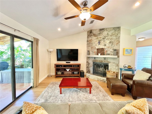 4370 NW 60th Ter, Gainesville, FL 32606 - living room featuring wood finished floors, a ceiling fan, vaulted ceiling, a fireplace, and baseboards