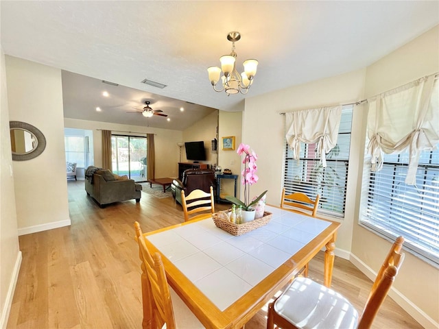 4370 NW 60th Ter, Gainesville, FL 32606 - dining space featuring light wood-type flooring, a chandelier, baseboards, and ceiling fan