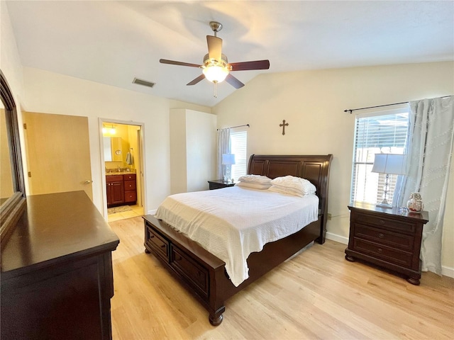 4370 NW 60th Ter, Gainesville, FL 32606 - bedroom featuring light wood-type flooring, vaulted ceiling, baseboards, a ceiling fan, and connected bathroom