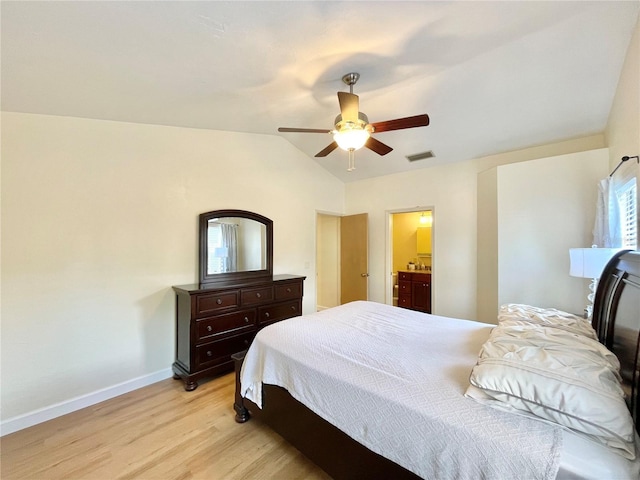 4370 NW 60th Ter, Gainesville, FL 32606 - bedroom featuring light wood finished floors, baseboards, a ceiling fan, lofted ceiling, and ensuite bathroom
