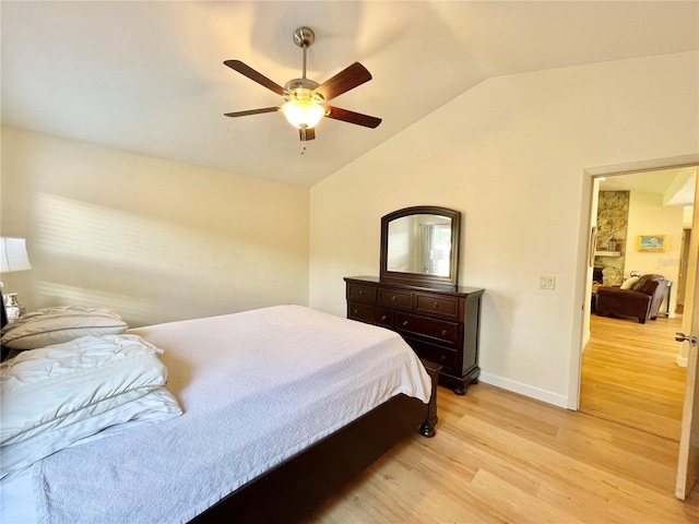 4370 NW 60th Ter, Gainesville, FL 32606 - bedroom with light wood-style flooring, vaulted ceiling, baseboards, and a ceiling fan