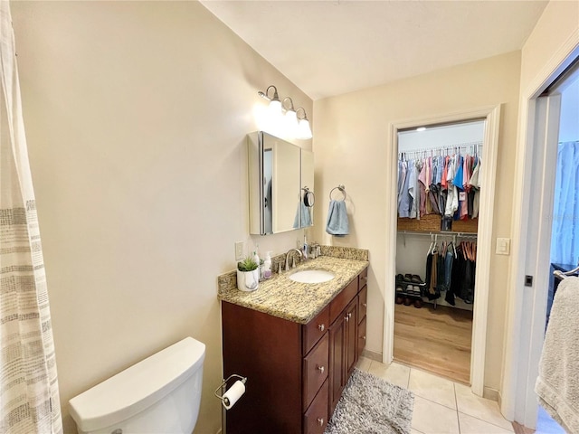 4370 NW 60th Ter, Gainesville, FL 32606 - bathroom with tile patterned flooring, vanity, toilet, and a spacious closet