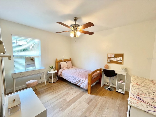 4370 NW 60th Ter, Gainesville, FL 32606 - bedroom with light wood finished floors, ceiling fan, and baseboards