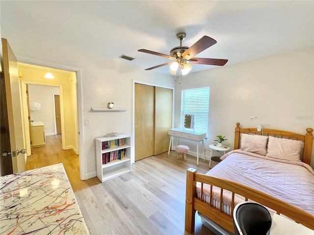 4370 NW 60th Ter, Gainesville, FL 32606 - bedroom with a closet, light wood-style floors, baseboards, and a ceiling fan