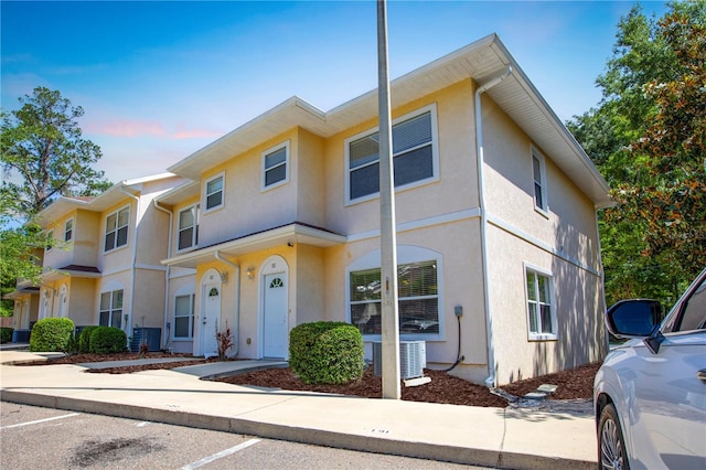 528 NW 39th Rd Unit 101, Gainesville, FL 32607 - view of property featuring stucco siding and central AC unit
