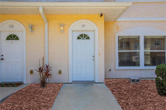 528 NW 39th Rd Unit 101, Gainesville, FL 32607 - doorway to property featuring stucco siding