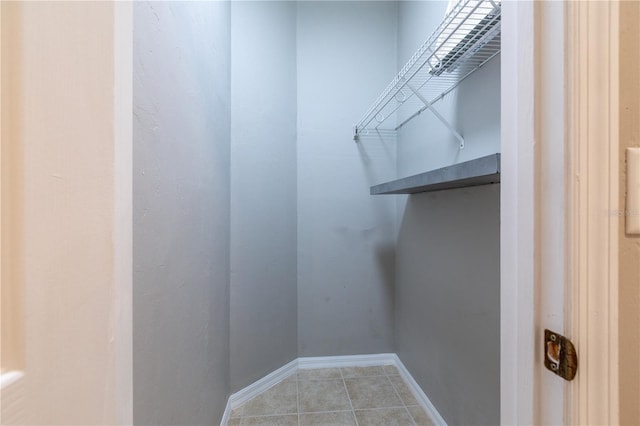528 NW 39th Rd Unit 101, Gainesville, FL 32607 - walk in closet featuring light tile patterned flooring