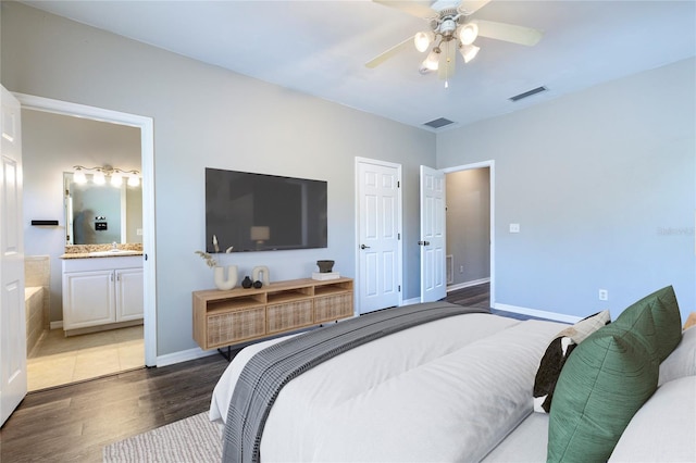 528 NW 39th Rd Unit 101, Gainesville, FL 32607 - bedroom with wood finished floors, baseboards, ensuite bathroom, a sink, and a ceiling fan