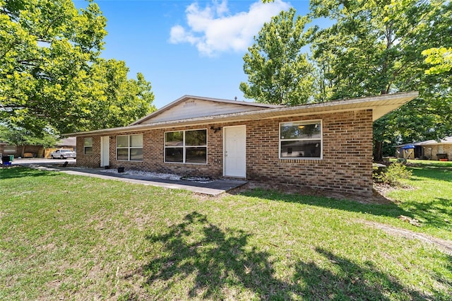 6117 NW 23rd Ter, Gainesville, FL 32653 - view of front facade with a front lawn and brick siding