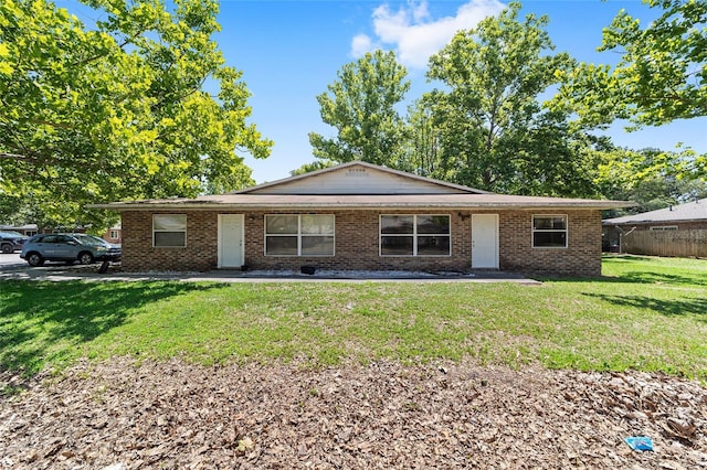 6117 NW 23rd Ter, Gainesville, FL 32653 - ranch-style house featuring a front yard and brick siding