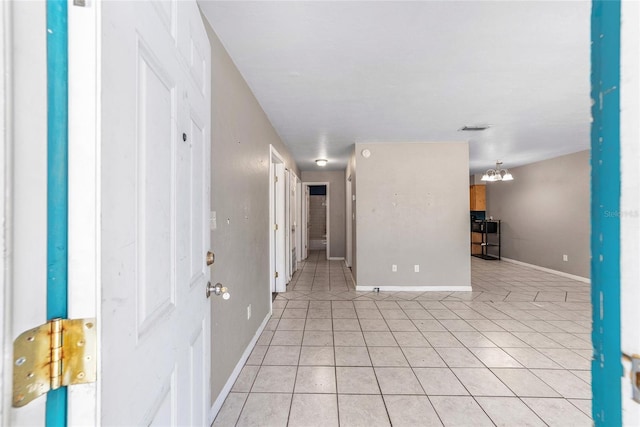6117 NW 23rd Ter, Gainesville, FL 32653 - spare room with light tile patterned floors, baseboards, and a chandelier