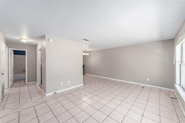 6117 NW 23rd Ter, Gainesville, FL 32653 - spare room featuring light tile patterned flooring, a chandelier, baseboards, and a smoke detector