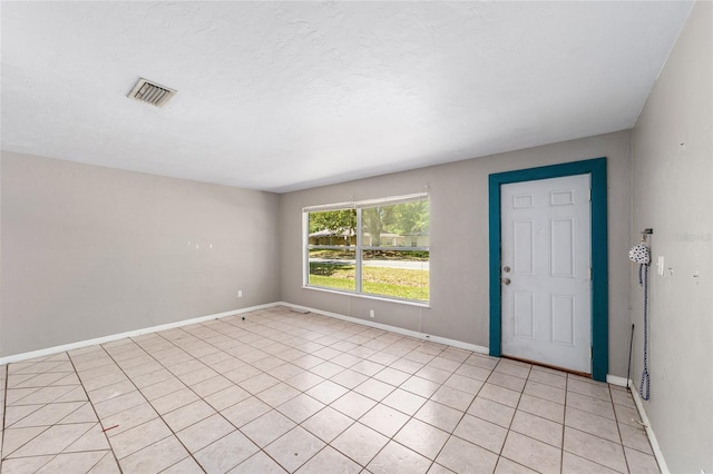 6117 NW 23rd Ter, Gainesville, FL 32653 - entryway featuring light tile patterned floors and baseboards