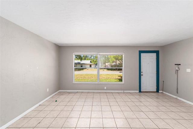 6117 NW 23rd Ter, Gainesville, FL 32653 - empty room with baseboards and light tile patterned floors