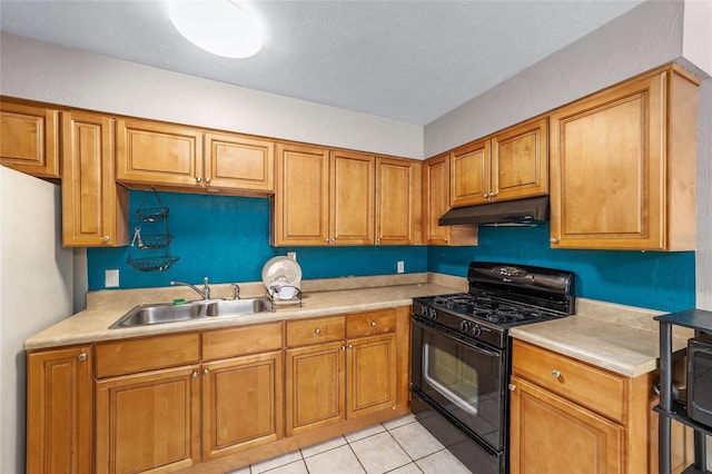 6117 NW 23rd Ter, Gainesville, FL 32653 - kitchen featuring black gas range, under cabinet range hood, a sink, light countertops, and freestanding refrigerator