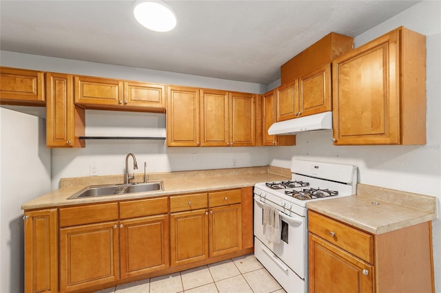 6117 NW 23rd Ter, Gainesville, FL 32653 - kitchen featuring white gas stove, a sink, under cabinet range hood, light countertops, and brown cabinets