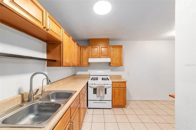 6117 NW 23rd Ter, Gainesville, FL 32653 - kitchen with under cabinet range hood, a sink, white gas stove, light tile patterned floors, and open shelves