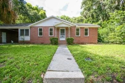 1627 NW 8th Ave, Gainesville, FL 32603 - ranch-style house with a front lawn and brick siding