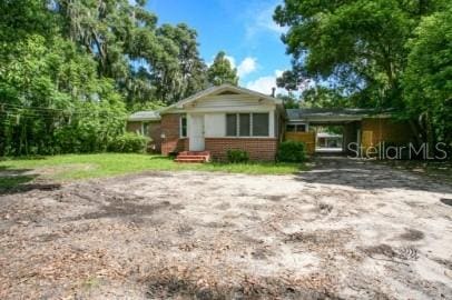 1627 NW 8th Ave, Gainesville, FL 32603 - view of front of property with brick siding and dirt driveway