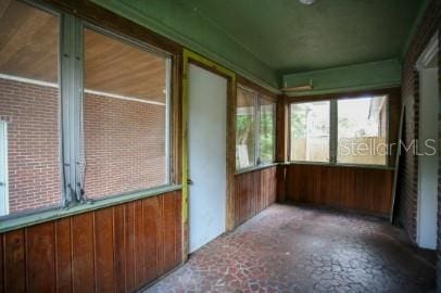 1627 NW 8th Ave, Gainesville, FL 32603 - unfurnished sunroom featuring wooden walls