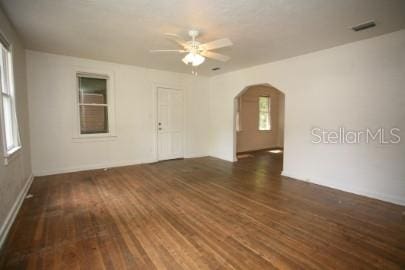 1627 NW 8th Ave, Gainesville, FL 32603 - empty room with arched walkways, wood finished floors, and a ceiling fan