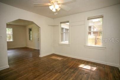 1627 NW 8th Ave, Gainesville, FL 32603 - spare room with a ceiling fan, baseboards, wood finished floors, and arched walkways