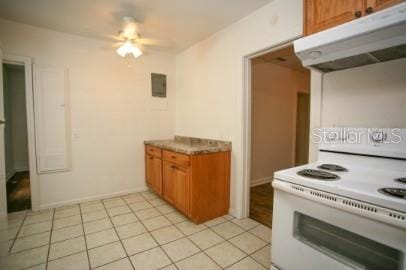 1627 NW 8th Ave, Gainesville, FL 32603 - kitchen featuring white electric range, under cabinet range hood, brown cabinetry, ceiling fan, and light tile patterned floors