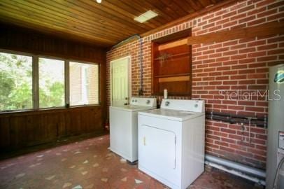 1627 NW 8th Ave, Gainesville, FL 32603 - laundry area with wood ceiling, brick wall, separate washer and dryer, wood walls, and water heater
