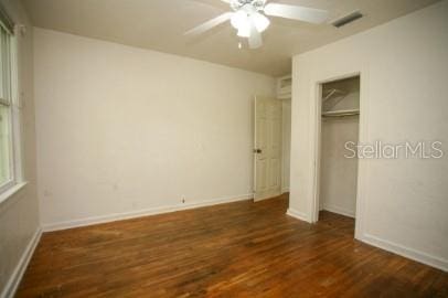 1627 NW 8th Ave, Gainesville, FL 32603 - unfurnished bedroom featuring dark wood finished floors, baseboards, a closet, and a ceiling fan