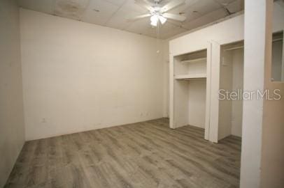 1627 NW 8th Ave, Gainesville, FL 32603 - unfurnished bedroom with wood finished floors and multiple closets