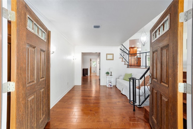 6015 SW 36th Way, Gainesville, FL 32608 - hallway featuring stairway, hardwood / wood-style floors, ornamental molding, and baseboards