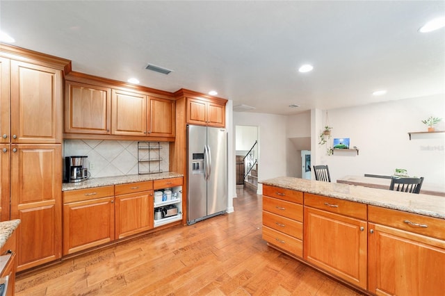 6015 SW 36th Way, Gainesville, FL 32608 - kitchen featuring stainless steel refrigerator with ice dispenser, light wood finished floors, tasteful backsplash, recessed lighting, and light stone counters