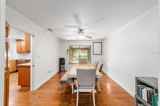 6015 SW 36th Way, Gainesville, FL 32608 - dining area featuring crown molding, a ceiling fan, light wood-style floors, and baseboards